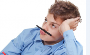 kid bored with pen on upper lip
